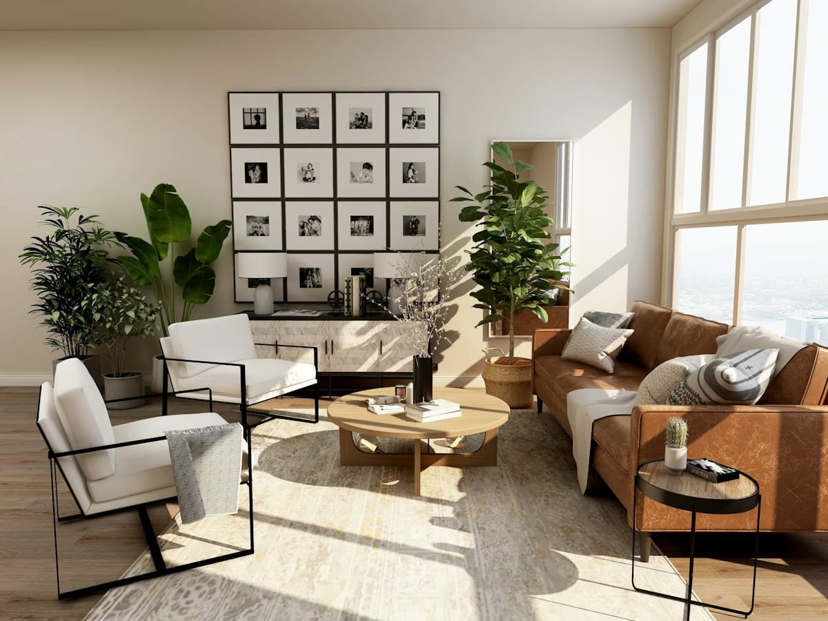 Sunlit living room with leather seating, indoor plants, and large windows